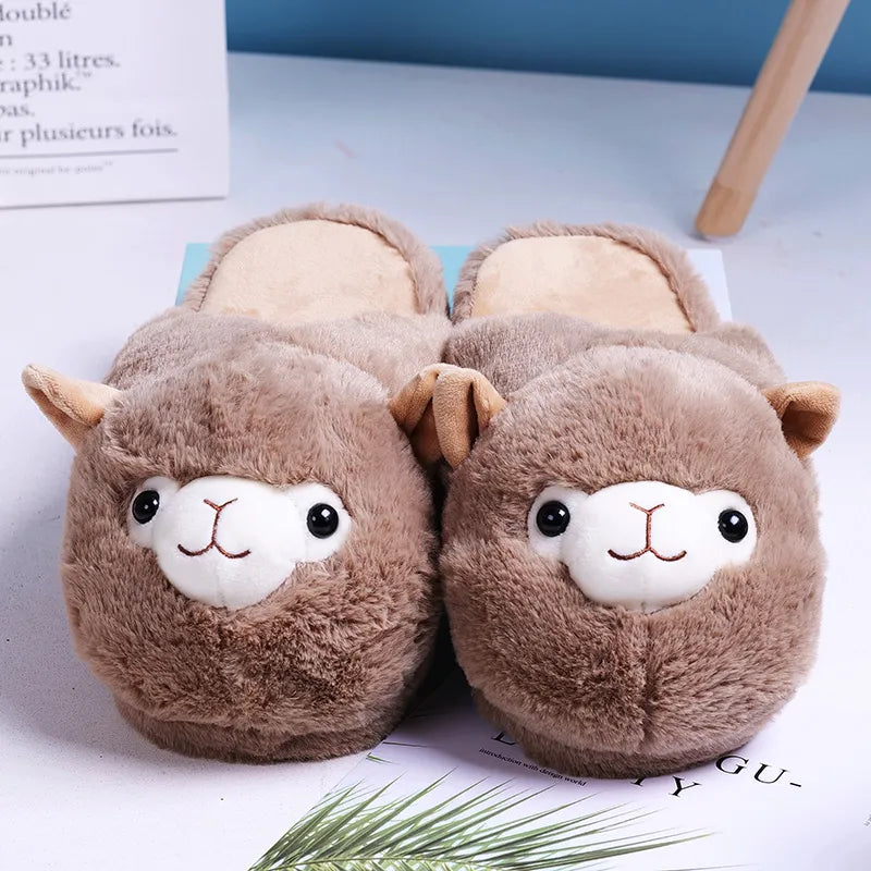 Brown plush slip-on slippers resembling smiling alpacas, featuring their charming faces on the front with delightful beaded eyes.