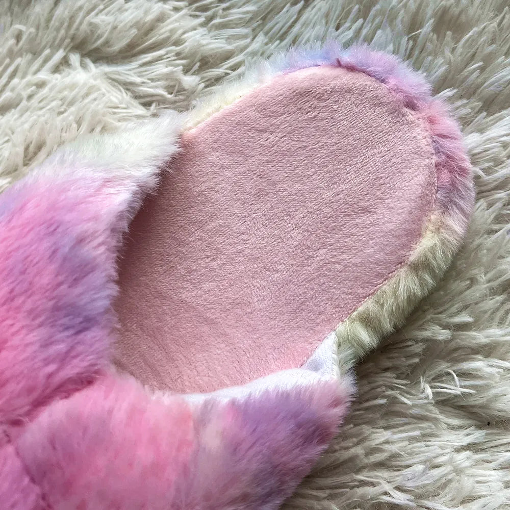 A close-up view showcasing the pink material lining inside the rainbow unicorn slip-on slippers.