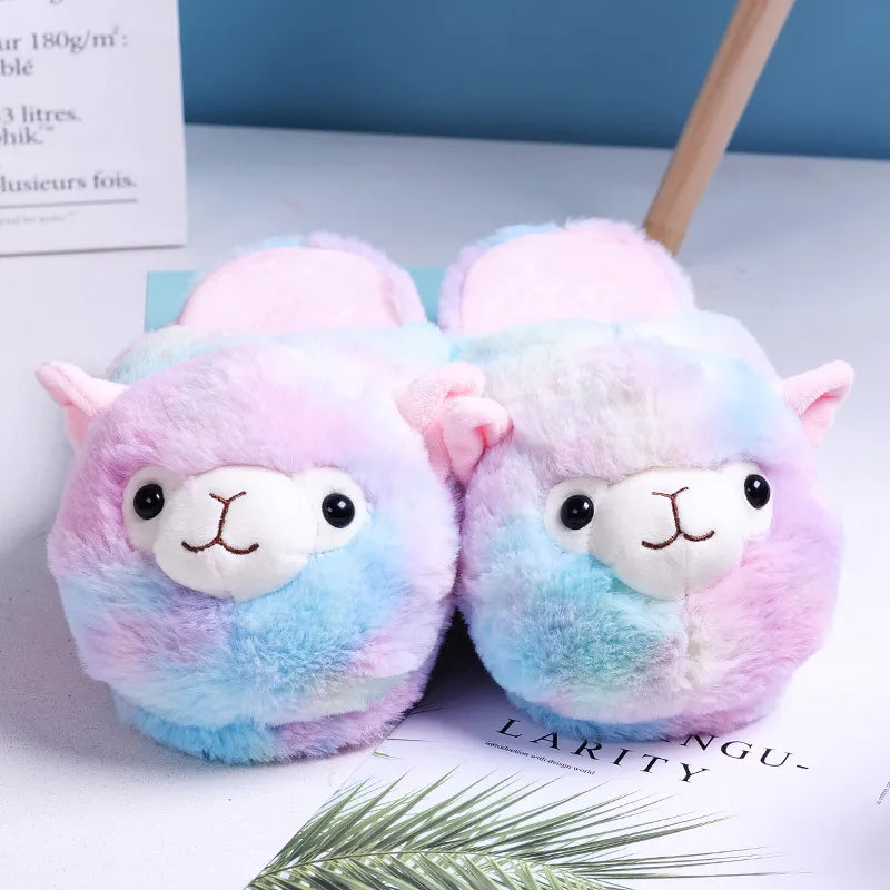 Rainbow plush slip-on slippers resembling smiling alpacas, featuring their charming faces on the front with delightful beaded eyes.